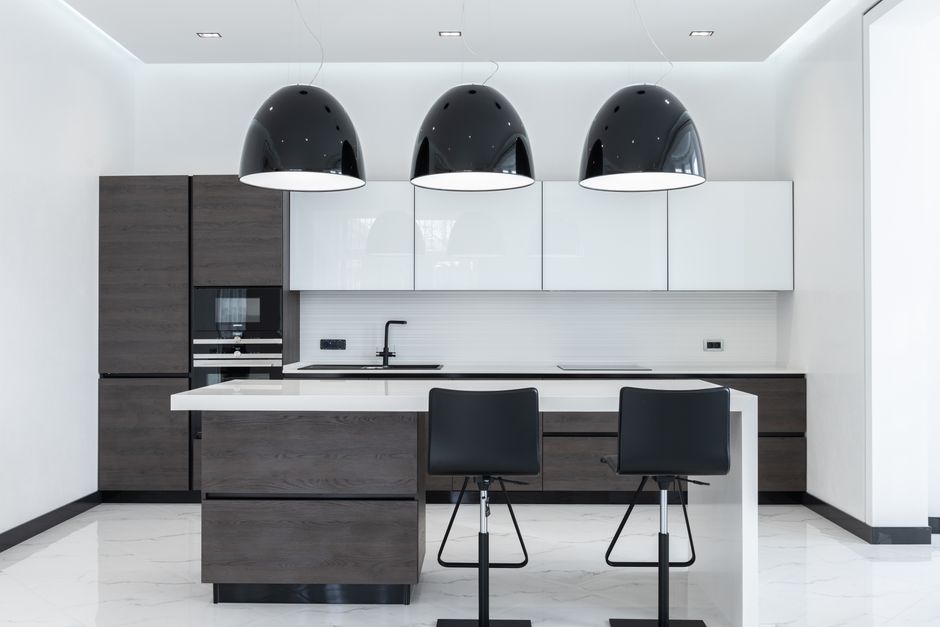 Renovated kitchen with an island, wood cabinets, and pendant lighting